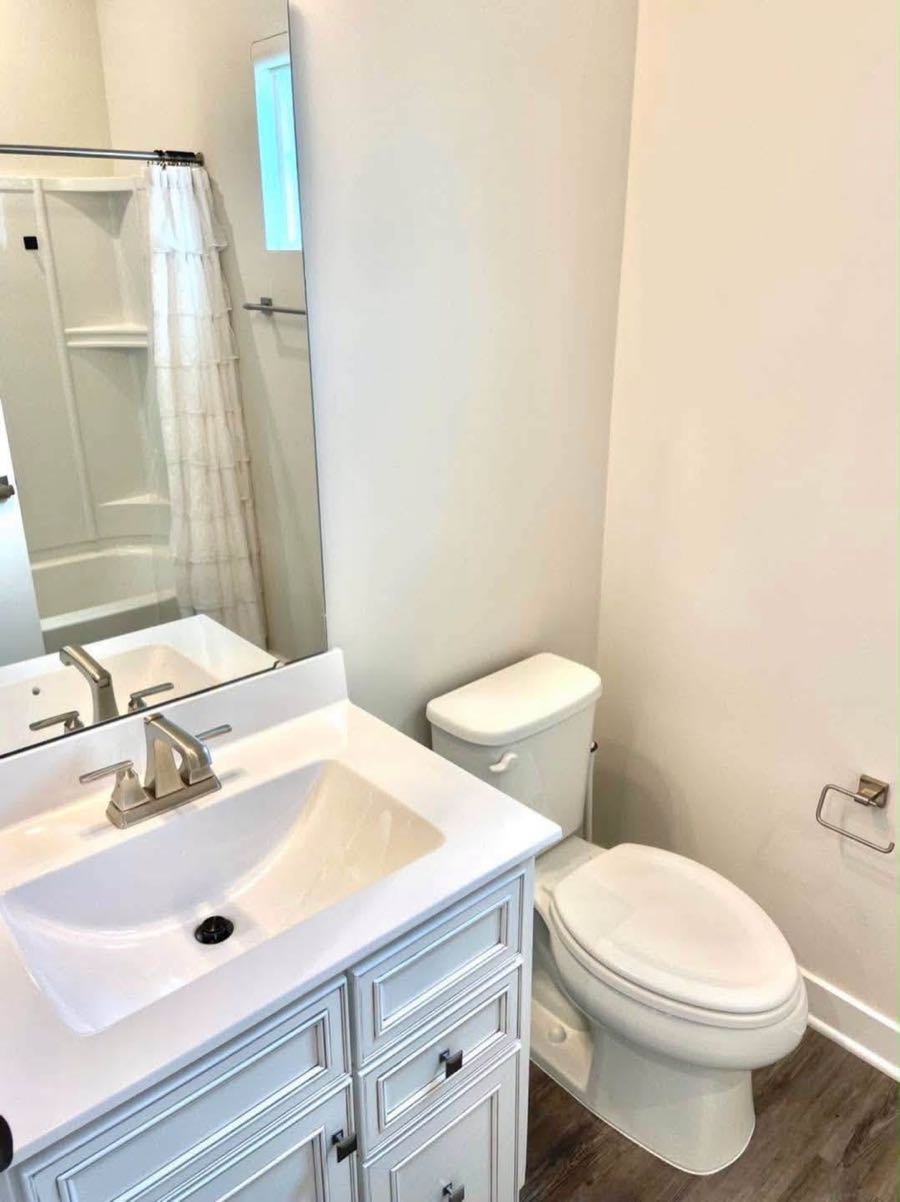 Guest bathroom with a white vanity